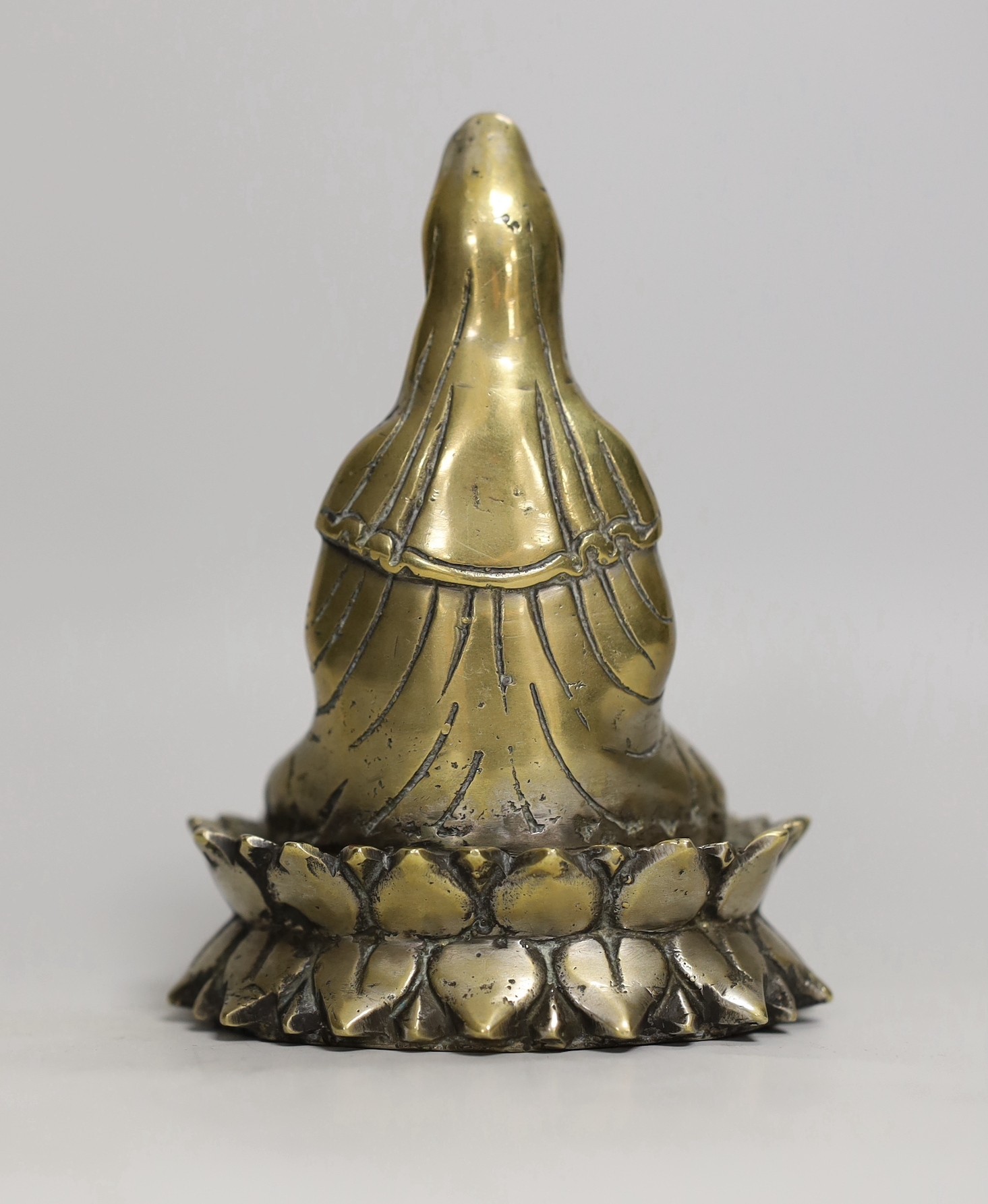 A Chinese bronze seated figure of Guanyin, 13cm